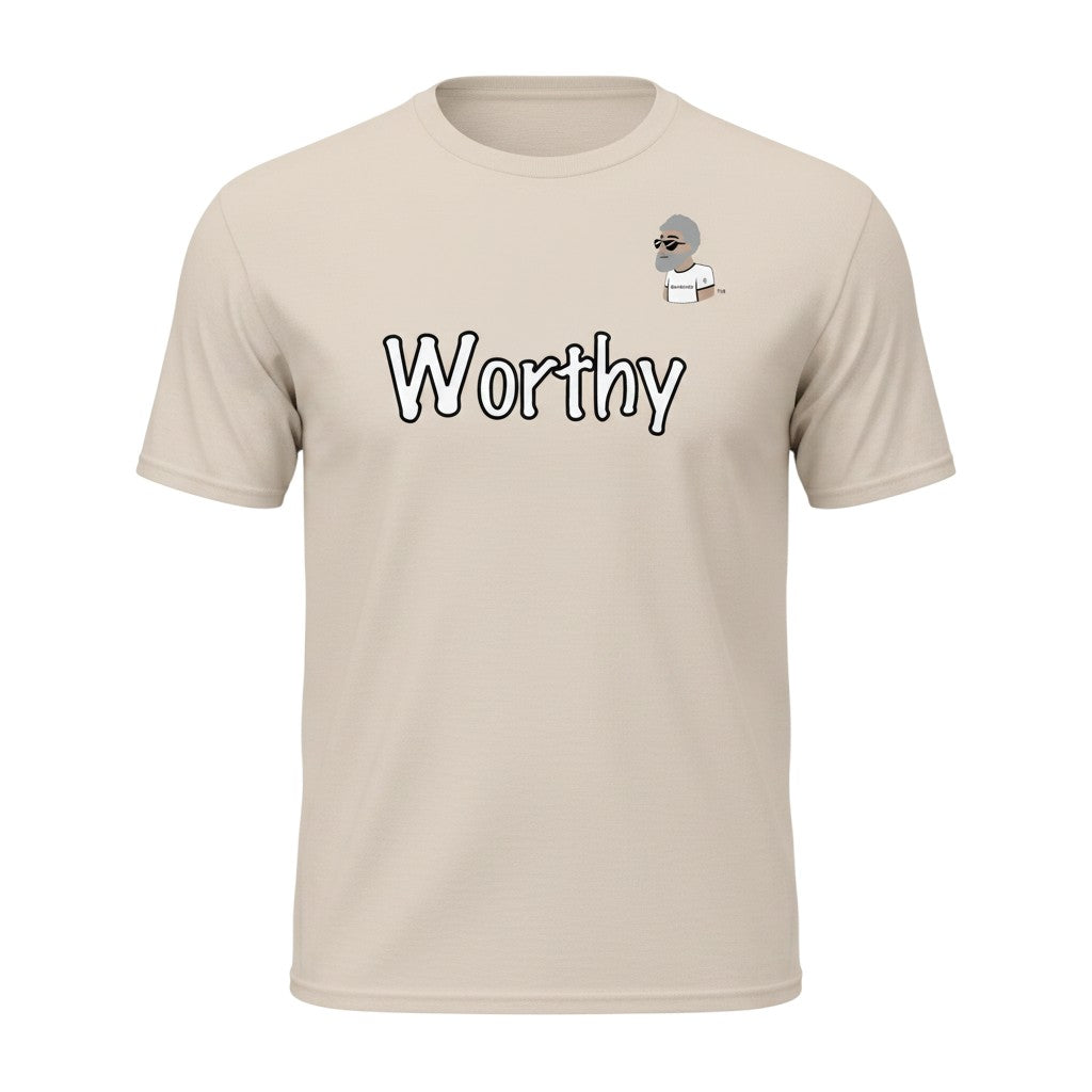 Big Daddy Allen Productions Worthy Graphic T-Shirt in beige, featuring a bold "Worthy" graphic and a small cartoon of a man with glasses.